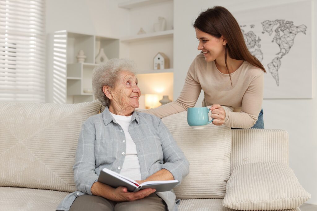 Elderly woman and young woman smiling together.