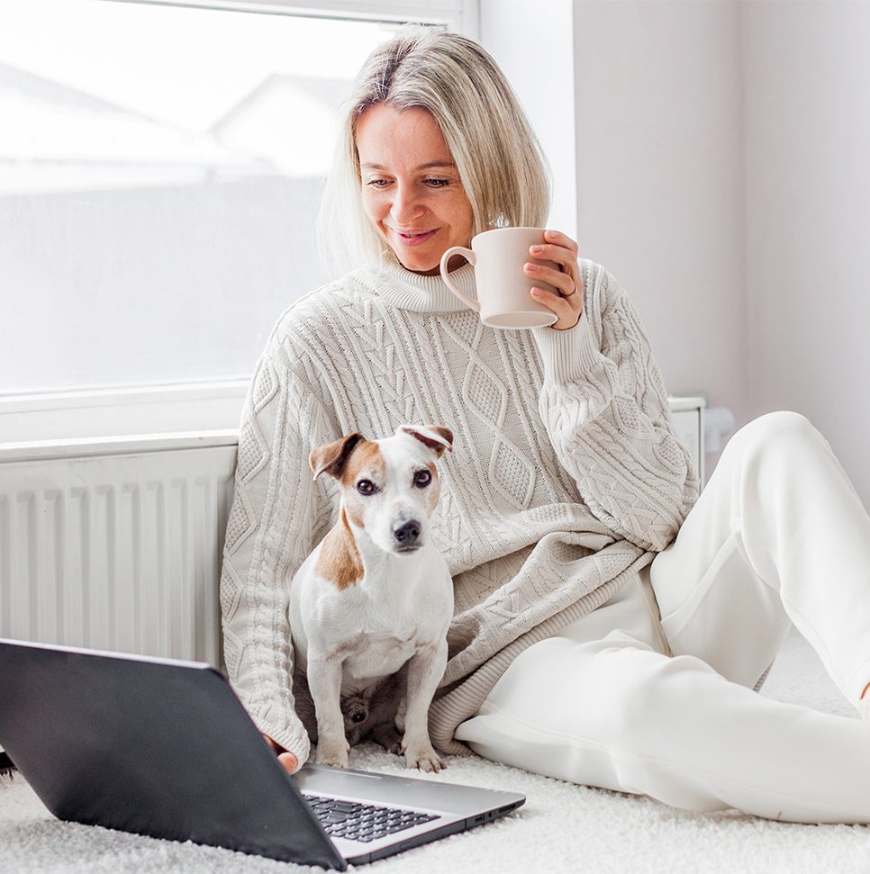 2 A woman sitting on the floor with her dog