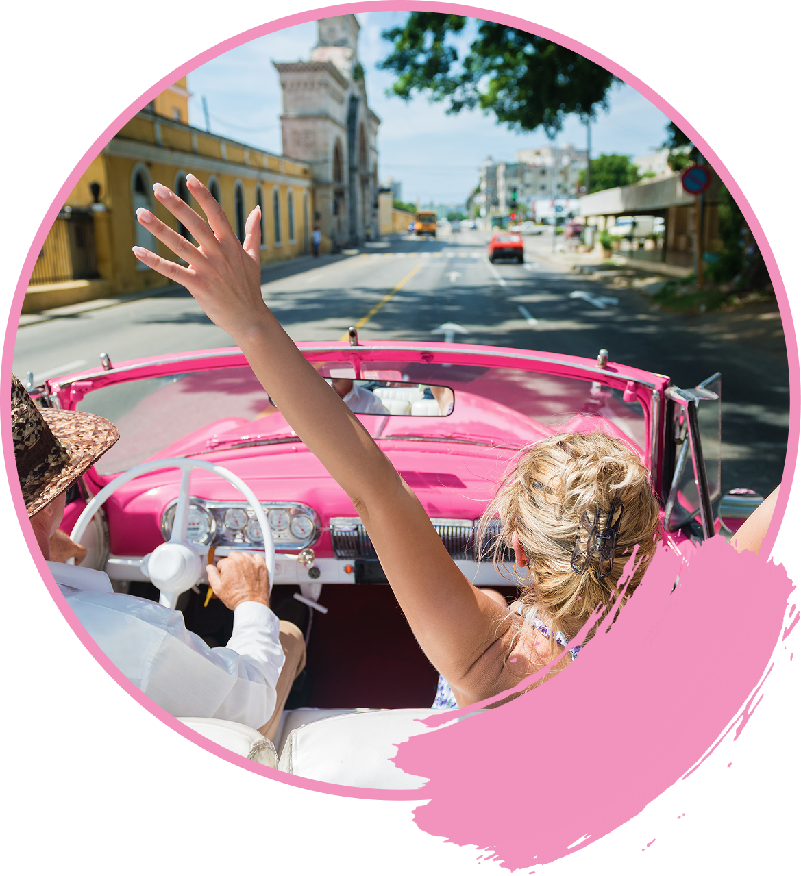 Group 5 A woman driving in a pink car with her hand up.