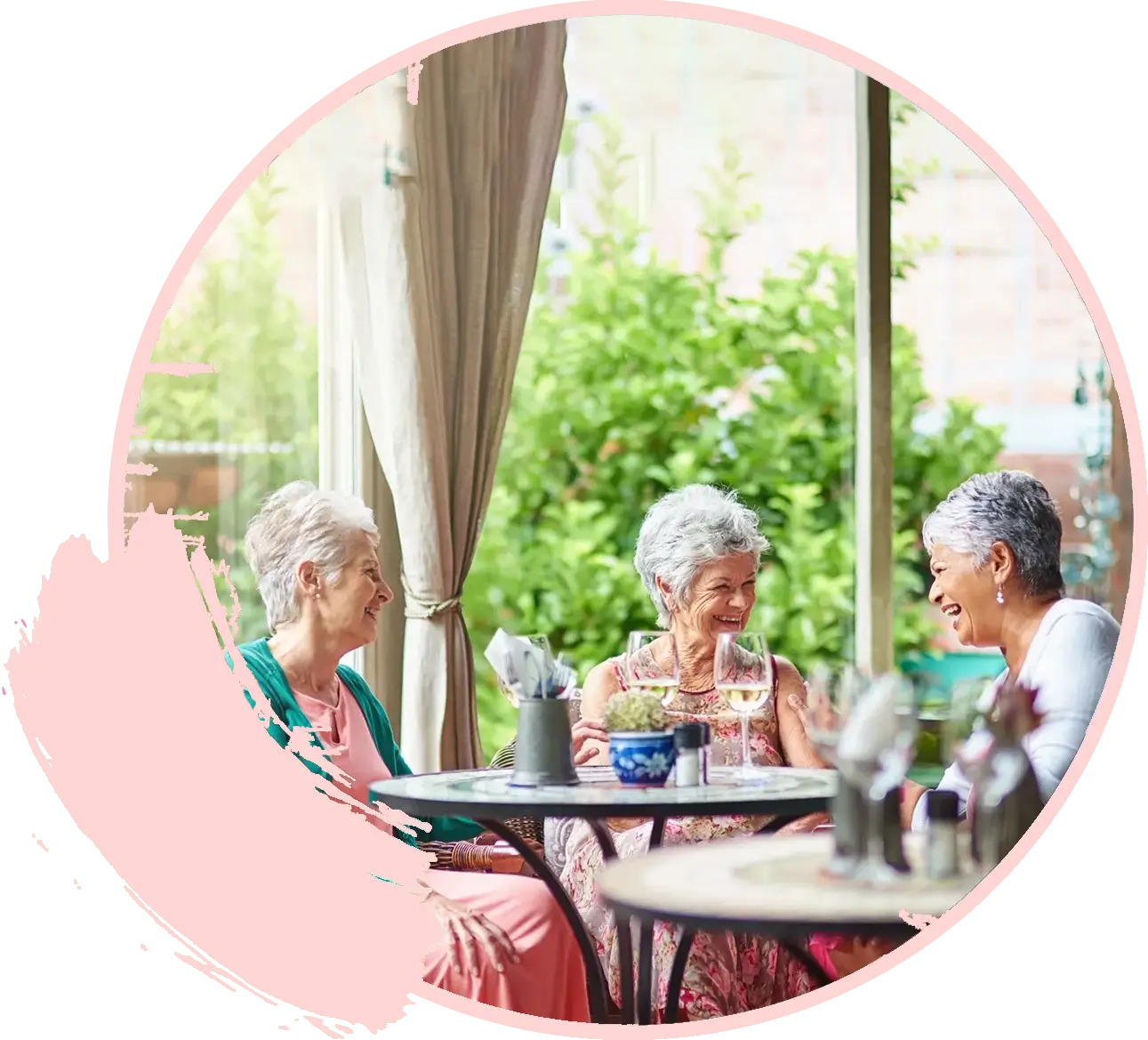Elderly women chatting at an outdoor cafe.