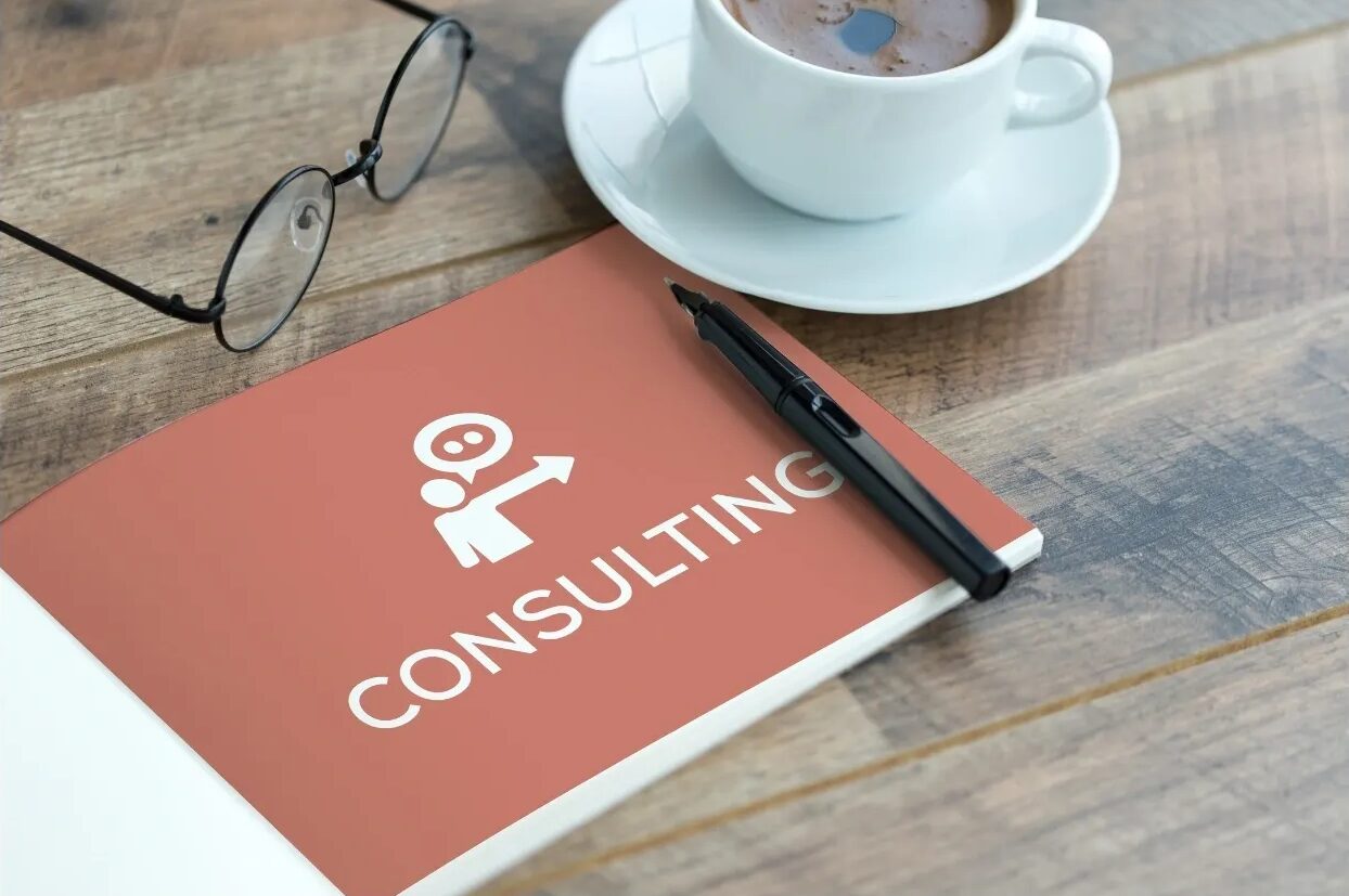 Consulting notebook with pen and coffee cup.