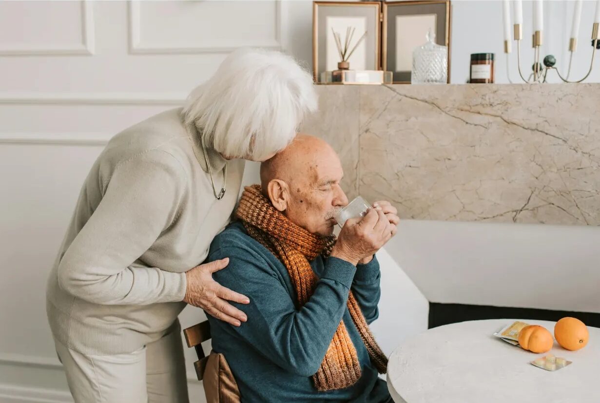 Elderly couple enjoying tea at home.
