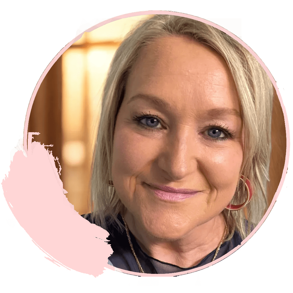 Smiling woman with blonde hair and earrings.