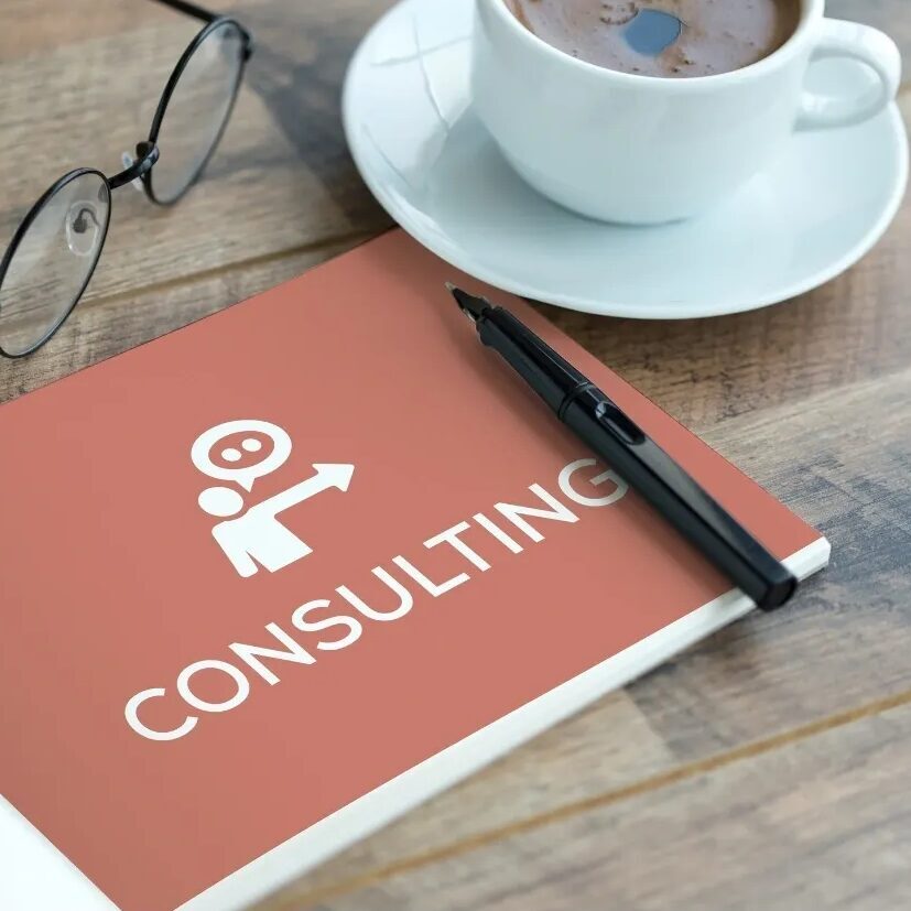 Consulting notebook with pen and coffee cup.